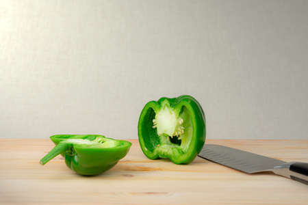 A sweet green pepper on the beige bachground