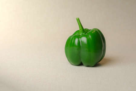 A sweet green pepper on the beige bachgroundの写真素材