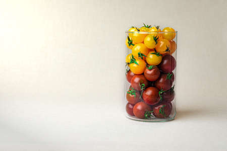 Cherry tomatoes at the linen background coloredの写真素材