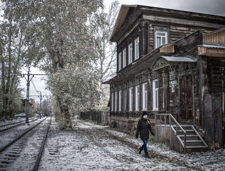 15th of October 2016. Russia, woman walks by old houseのeditorial素材