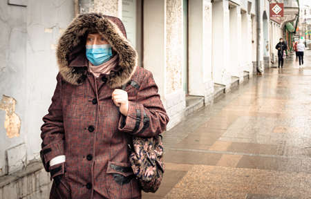 26th of October 2020, Russia, Tomsk, woman with medical mask on streetのeditorial素材