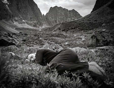 30th of July 2018, Russia, Kodar mountain region, mountaineer sleeps on halt in mountainsのeditorial素材