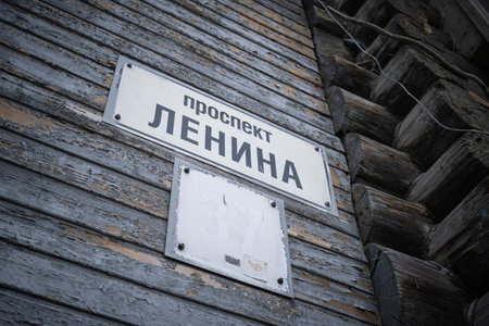 15th of June 2022, Russia, Tomsk, a tablet with note in russian LENIN AVENUE on old wooden wallのeditorial素材