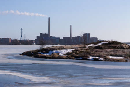 Industrial landscape over a rocky ocean shoreの写真素材