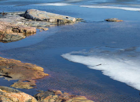 Rocky ocean shore with iceの写真素材