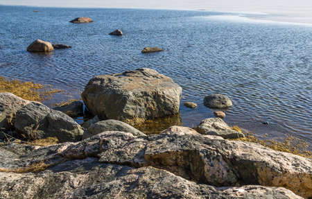 Rocks in the icy ocean shoreの写真素材