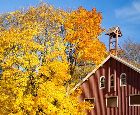 Old wooden darn surrounded by the bright autumn colorsの写真素材
