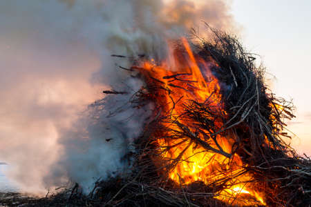 Smoking easter bonfire set on the lake ice