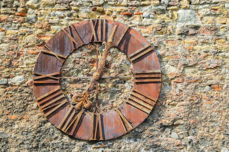 Old Zagreb Cathedral clock mounted on the stone wallの写真素材