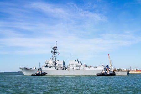 HELSINKI, FINLAND - 3. July, 2015. Tugboats  helping destroyer USS Jason Dunham dock the Helsinki port on a friendly visitのeditorial素材