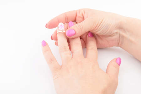 female hands and wedding ring on white backgroundの写真素材