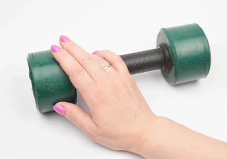 female hand and green old dumbbellの写真素材