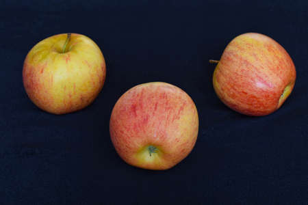 three apple on dark backgroundの写真素材