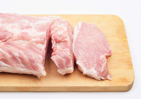 pork chop meat on a cutting wooden boardの写真素材