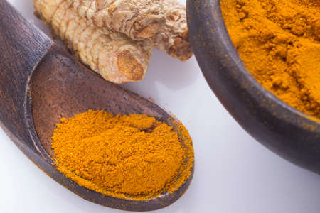 Turmeric powder and rootsの写真素材