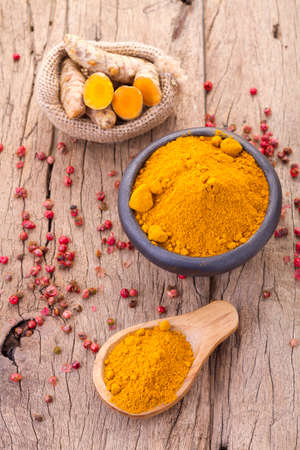 Turmeric powder and rootsの写真素材