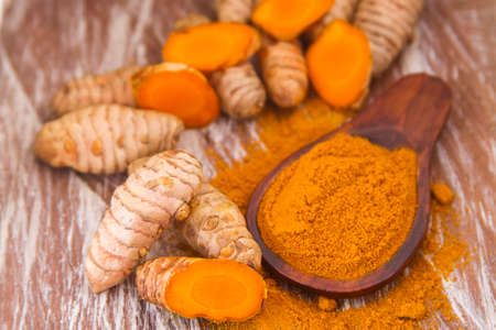 Turmeric powder and rootsの写真素材