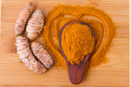 Turmeric powder and rootsの写真素材