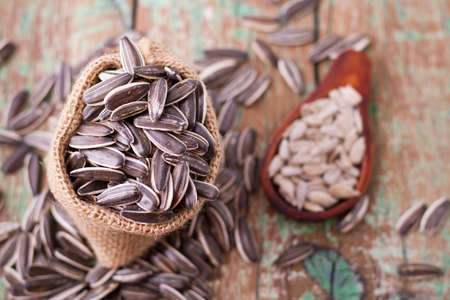 sunflower seeds on the wooden table (Helianthus annuus)の写真素材