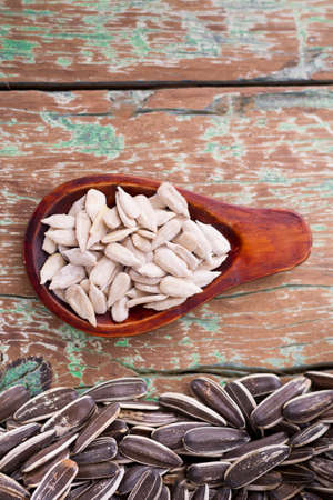 sunflower seeds on the wooden table (Helianthus annuus)の写真素材