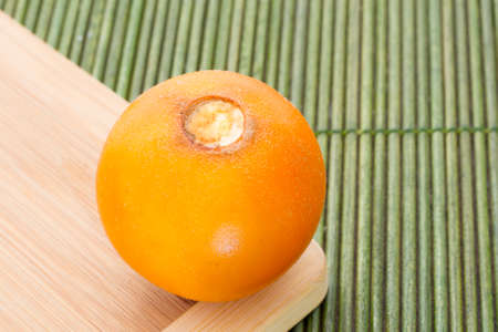 Fruits and slices of lulo or naranjilla on the wooden table - Solanum quitoenseの写真素材