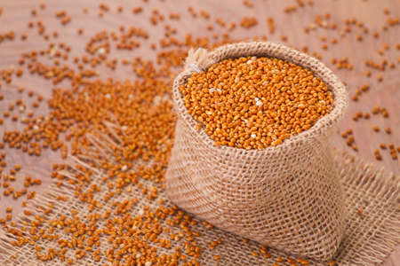 red millet seeds on wooden background, super foodの写真素材