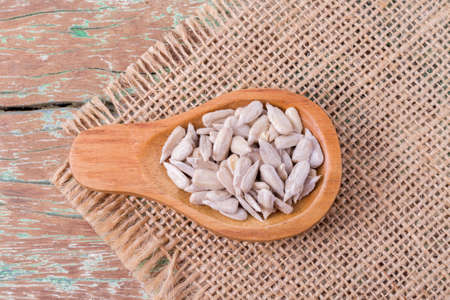 sunflower seeds on the wooden table (Helianthus annuus)の写真素材