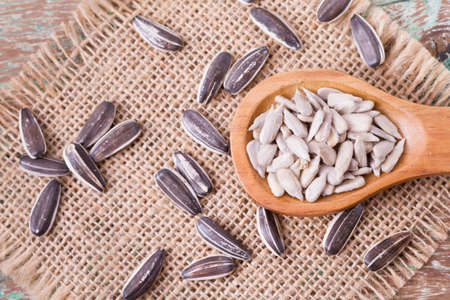 sunflower seeds on the wooden table (Helianthus annuus)の写真素材