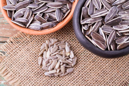 sunflower seeds on the wooden table (Helianthus annuus)の写真素材