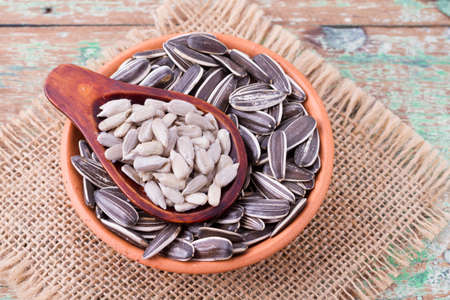 sunflower seeds on the wooden table (Helianthus annuus)の写真素材