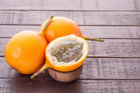 Passion fruit granadilla on the table - Passiflora ligularisの写真素材