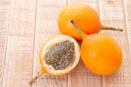Passion fruit granadilla on the table - Passiflora ligularisの写真素材