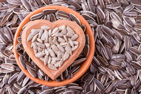sunflower seeds on the wooden table (Helianthus annuus)の写真素材