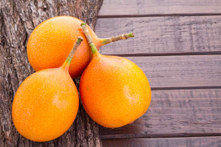 Passion fruit granadilla on the table - Passiflora ligularisの写真素材