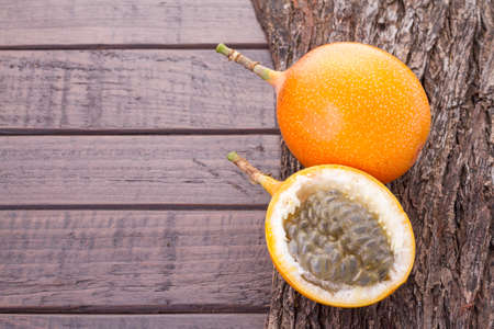 Passion fruit granadilla on the table - Passiflora ligularisの写真素材