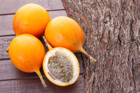 Passion fruit granadilla on the table - Passiflora ligularisの写真素材