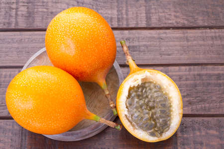 Passion fruit granadilla on the table - Passiflora ligularisの写真素材