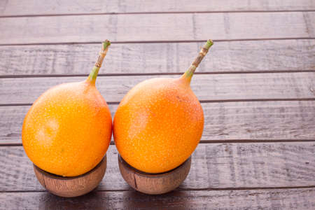 Passion fruit granadilla on the table - Passiflora ligularisの写真素材