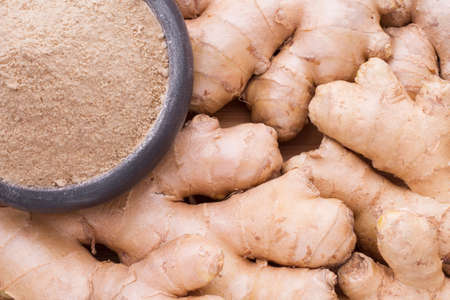 Roots and ginger powder on the table, top viewの写真素材
