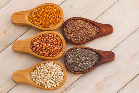 wooden spoons with assorted grains of super foods, gluten freeの写真素材