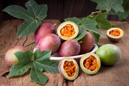 fruits of gulupa on vine wood table, Passiflora pinnatistipulaの写真素材