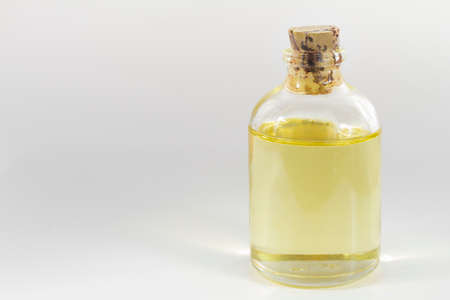 glass jar with castor oil isolated on white backgroundの写真素材
