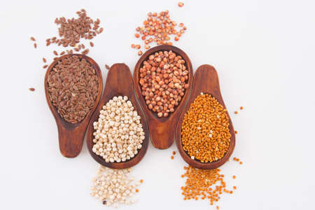 sorghum, millet and flaxseed in spoon.