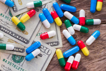 dollar bills and medicine capsules, medicine purchase concept.の写真素材