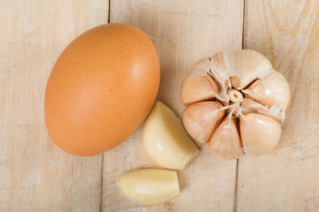 chicken and garlic eggs on the wooden table.