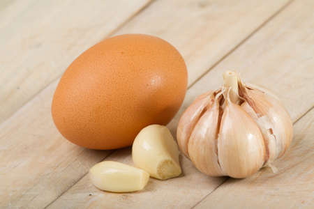 chicken and garlic eggs on the wooden table.の写真素材