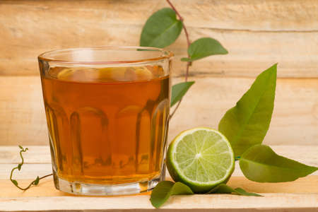 glass with lemon tea on wood.の写真素材
