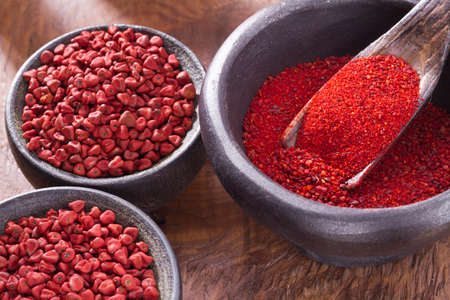 achiote in bowl on wooden background, achiote pasteの写真素材
