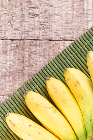 banana fruit on the wooden table (Musa Ã paradisiaca).の写真素材
