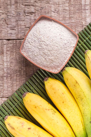 fruit and banana powder on the wooden table (Musa Ã paradisiaca).の写真素材